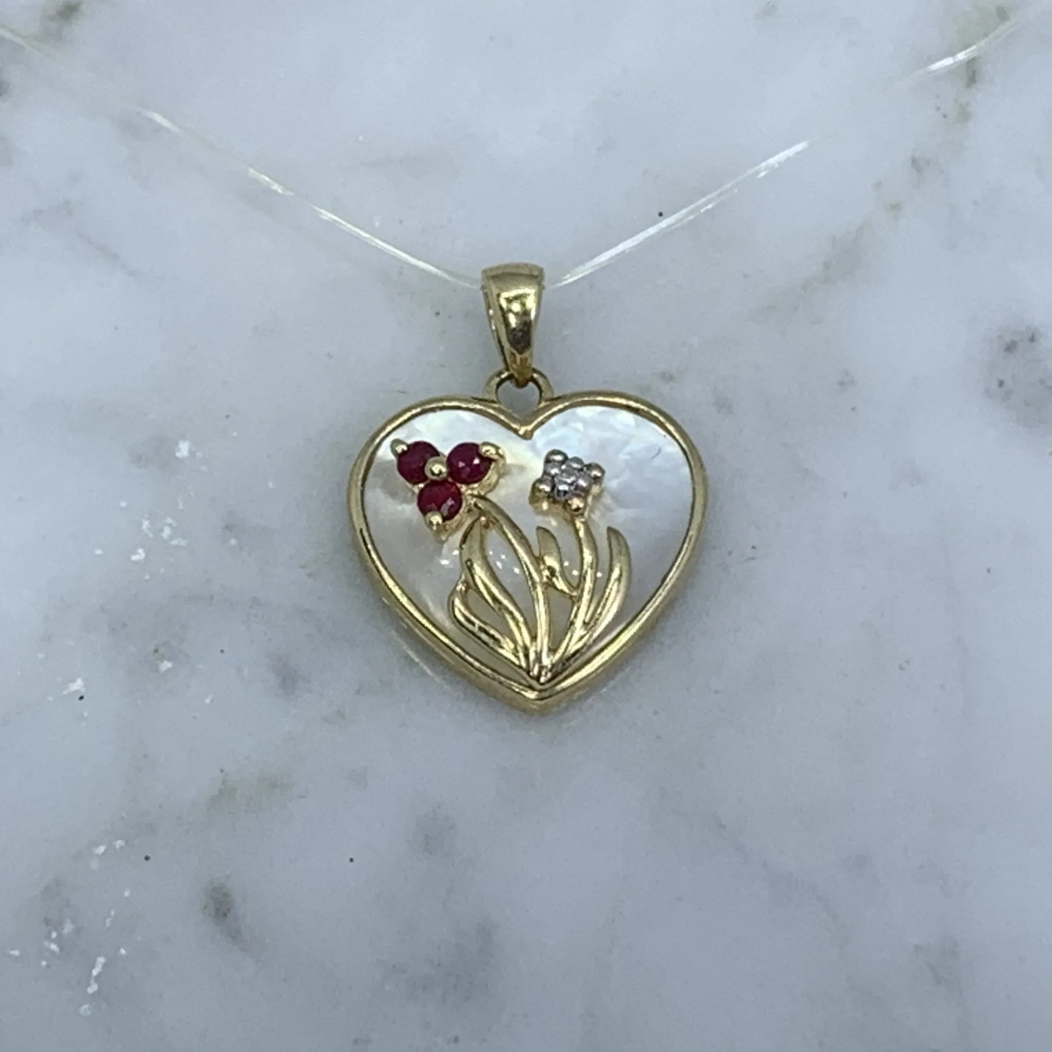 1960s Heart Shaped Mother of Pearl Pendant with Diamond and Ruby Flowers set in 10k Yellow Gold.